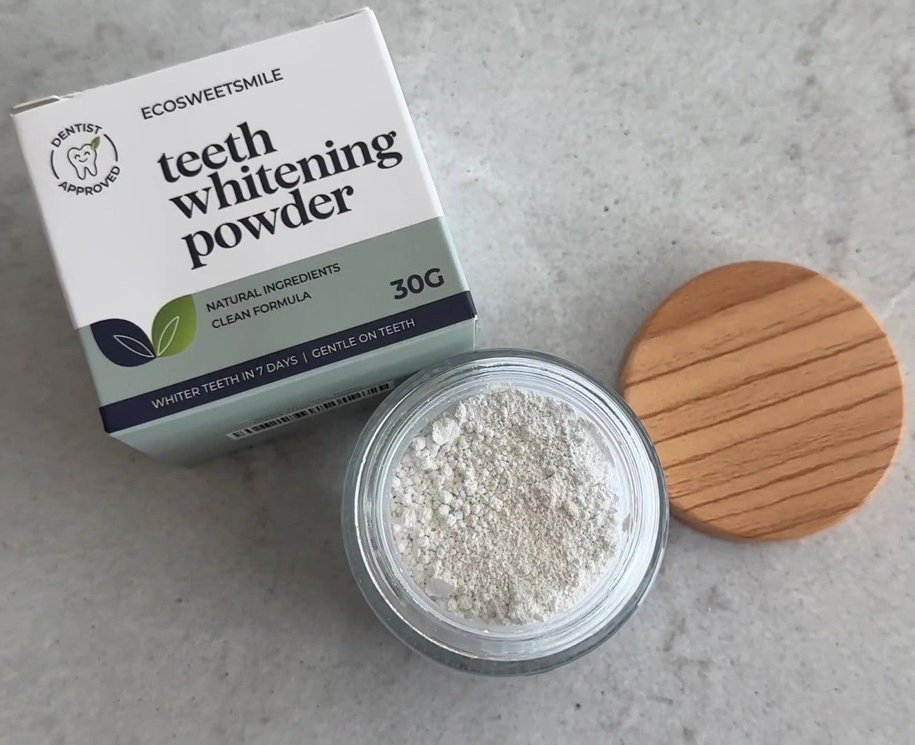 Top view of EcoBrightSmile teeth whitener packaging box with teeth whitening powder jar and lid on table